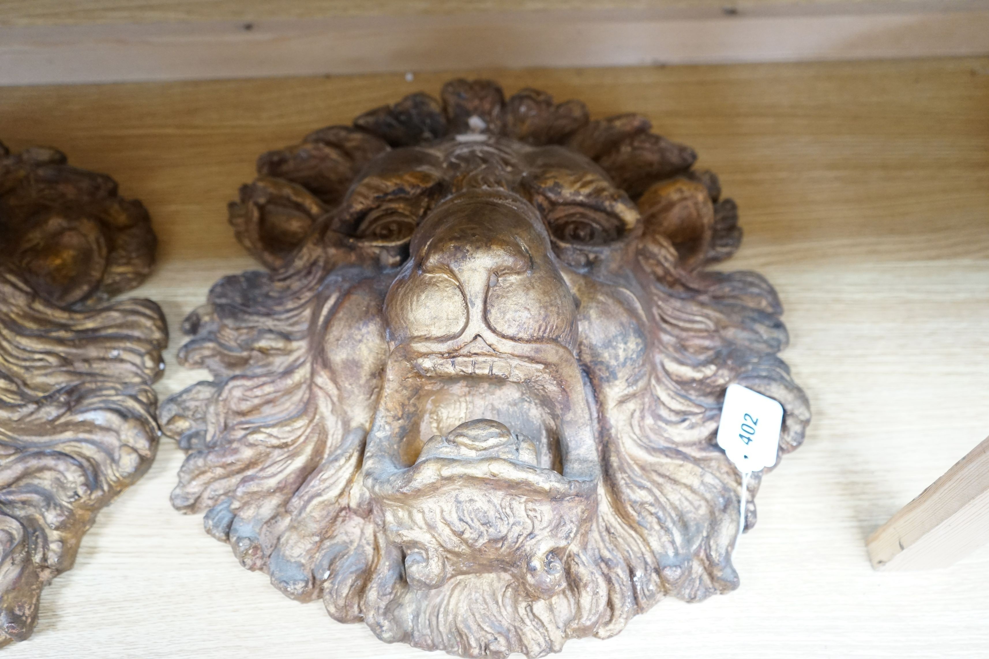 A pair of large decorative gilt plaster lion masks, 42cm